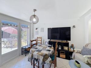 a living room with a flat screen tv and a couch at Le Nevoy in Nevoy