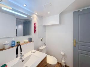 a bathroom with a sink and a toilet and a mirror at Le Nevoy in Nevoy +32 photos