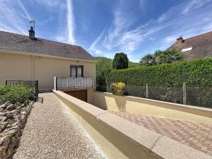 a house with a walkway next to a fence at Le Nevoy in Nevoy