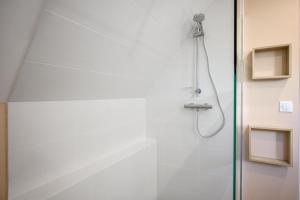 a shower in a bathroom with a glass door at Maison La Mirabelle in Thann +20 photos