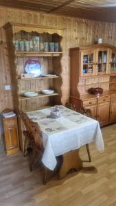 a dining room with a white table and wooden walls at Le montagnard in Lullin