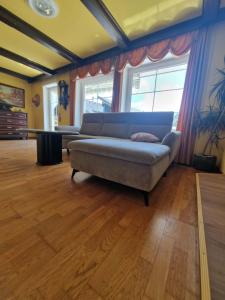 a living room with a couch in a room at Apartma Regrat in Lesce