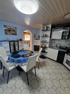 a kitchen and dining room with a table and chairs at Apartma Regrat in Lesce