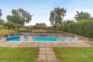 a group of chairs sitting next to a pool at 2 Bed in Overton oc-k45280 in Overton