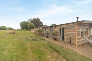 a log cabin with a deck and a yard at 2 Bed in Overton oc-k45280 in Overton
