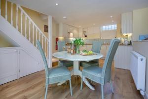 a kitchen and dining room with a table and chairs at 1 Abiff Place in Sidmouth