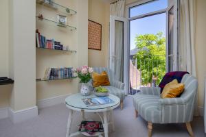 a living room with two chairs and a table at 1 Abiff Place in Sidmouth