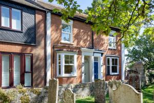 an old brick house with a stone fence at 1 Abiff Place in Sidmouth