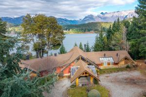 Luftaufnahme eines Hauses mit See und Bergen in der Unterkunft Peninsula Petit in San Carlos de Bariloche