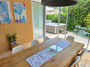 a dining room with a wooden table and chairs at Villa Dvojac Holiday house with Jacuzzi and grill in Jadranovo