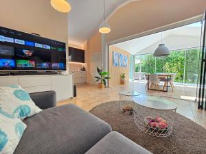 a living room with a couch and a table at Villa Dvojac Holiday house with Jacuzzi and grill in Jadranovo