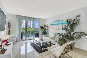 a living room with a couch and a table at Luxury Miami Condos - 1BR-2BR & 3BR in Miami Beach