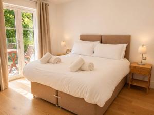 a bedroom with a large bed with two pillows on it at Watersmeet Point in Lynmouth