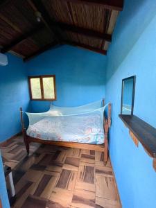 a bed in a room with a blue wall at Jardin Secreto in El Viejo +32 photos