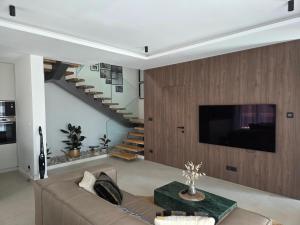 a living room with a couch and a tv at Villa Tedi in Podaca
