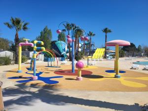 a playground in a park with a water park at La Carabasse-Vias "Te Mahana" in Vias
