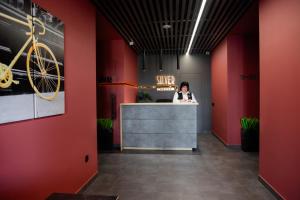 a woman is sitting at a counter in a salon at HOUSE silver in Ivano-Frankivsk