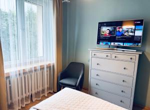 a bedroom with a dresser with a television on it at Akacja Centrum Apartament in Rzeszów