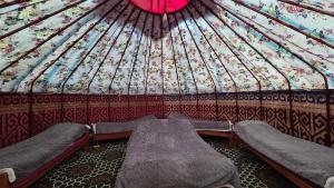 a room with two beds in a yurt at Emin Sky Camp in Mineralʼnyy Istochnik Altyn-Arasan +35 photos