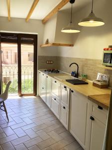 a kitchen with white cabinets and a counter top at Casa Charly in Almócita +20 photos