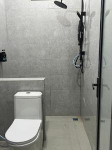 a bathroom with a toilet and a shower at Luminara Villa Kuala Besut in Kampung Kuala Besut