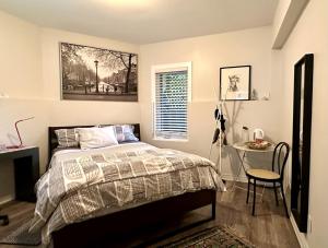 a bedroom with a bed and a table and a window at A Gem Downton Montreal in Montreal