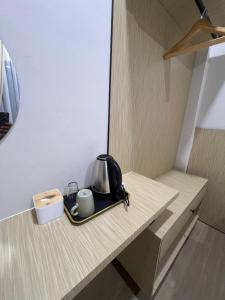 a tea kettle and cups on a tray on a kitchen counter at Luminara Villa Kuala Besut in Kampung Kuala Besut
