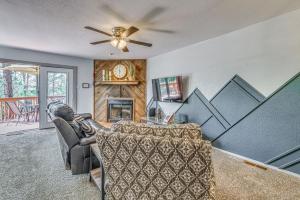 a living room with a couch and a fireplace at Hike, Golf & Explore: Ruidoso Retreat w/ Deck! in Ruidoso