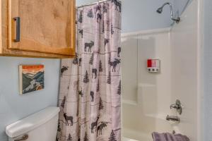 a bathroom with a shower curtain with deer on it at Hike, Golf & Explore: Ruidoso Retreat w/ Deck! in Ruidoso +24 photos