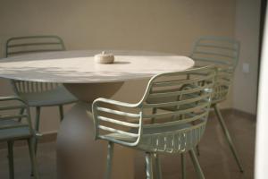 a table and chairs with a candle on top of it at Phi Aegina in Agia Marina Aegina +26 photos