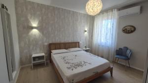 a bedroom with a bed and a blue chair at CasaLù in Lanciano