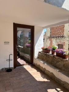 a door to a building with potted plants on it at Da Noi Panoramic Guest Stay Camera Rifugio in Cuorgnè +14 photos