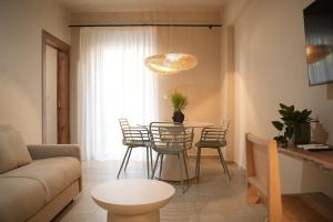 a living room with a table and chairs at Phi Aegina in Agia Marina Aegina