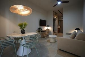 a living room with a couch and a table at Phi Aegina in Agia Marina Aegina