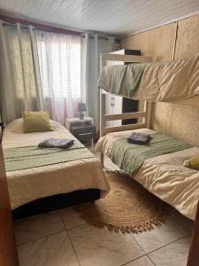a bedroom with two bunk beds and a window at Casa en Chuy in Chuy +29 photos