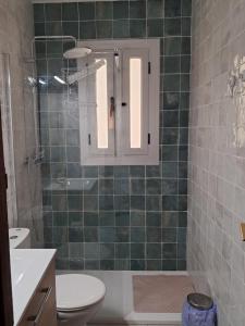 a bathroom with a toilet and a sink at Cal Jamila in Cubelles +21 photos