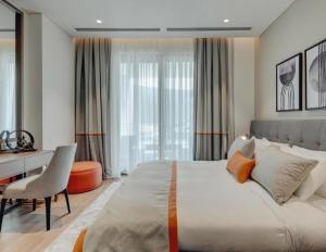 a bedroom with a large white bed and a desk at Portonovi Marina in Kumbor