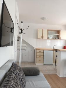 a living room with a table and a kitchen at Apartman studio in Privlaka +24 photos