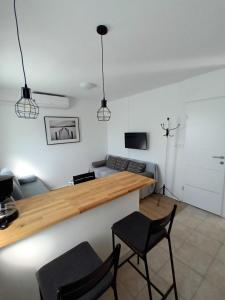 a living room with a table and two chairs at Apartman studio in Privlaka