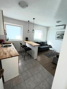 a kitchen and living room with a table and chairs at Apartman studio in Privlaka