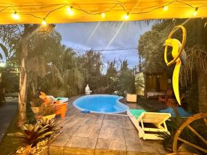 a swimming pool in a backyard with a tent at Casa en Chuy in Chuy