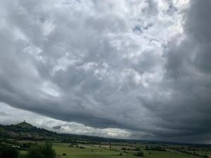 a cloudy sky over a green field with trees at Magic of Avalon in Glastonbury +36 photos