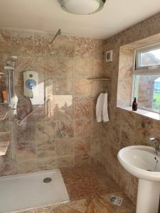 a bathroom with a shower and a sink at Magic of Avalon in Glastonbury