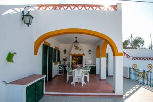 a kitchen and dining room of a house with an archway at Casa dos Alpendres in Avis
