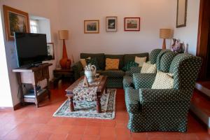 a living room with a couch and a table at Casa dos Alpendres in Avis
