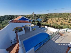 a villa with a swimming pool and a view at Casa dos Alpendres in Avis