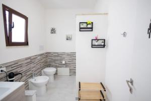 a bathroom with two toilets and a sink at Esmeralda Guest House in Cinisi +33 photos