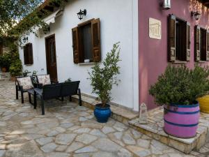 a black bench sitting in front of a house at Spiti Ouranoupoli in Ouranoupoli