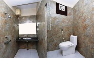 a bathroom with a toilet and a shower at Hotel shanti palace in Agra +17 photos