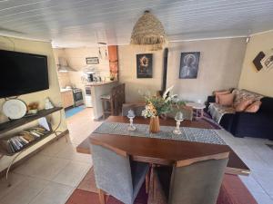 a living room with a table and a couch at Casa en Chuy in Chuy